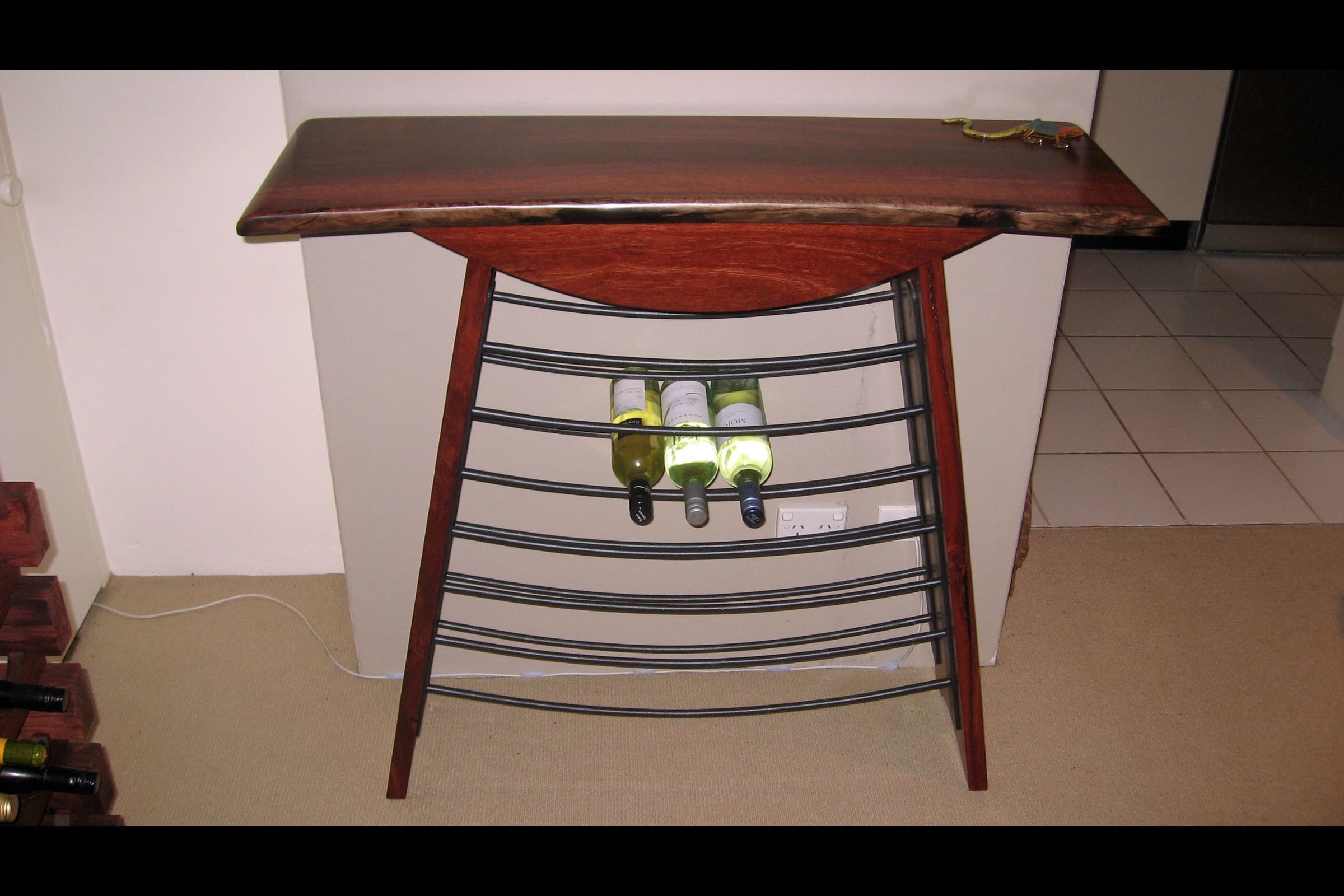 Finished jarrah wine rack showing the deep red-brown grain