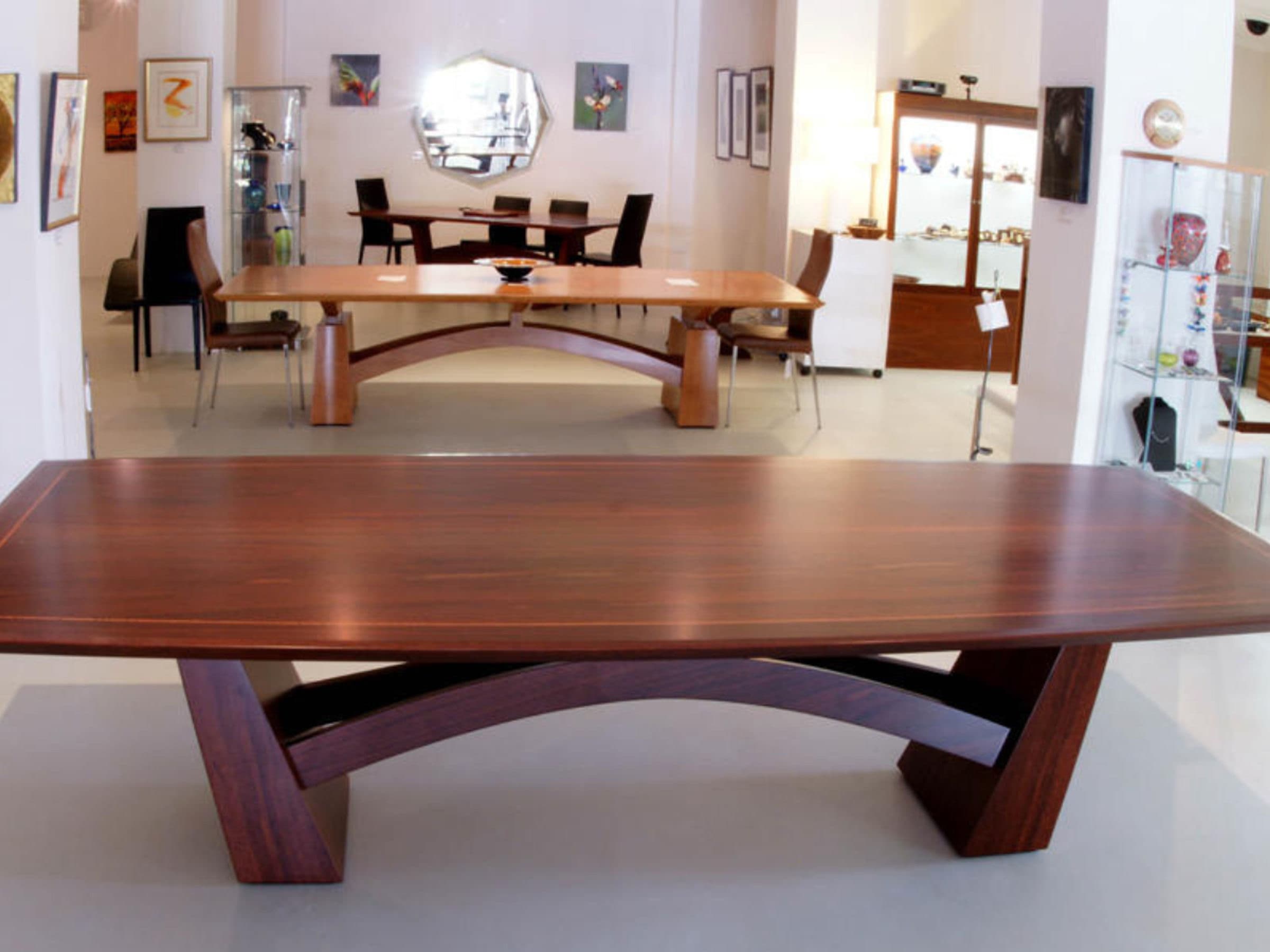 Two arched jarrah dining tables on the gallery floor