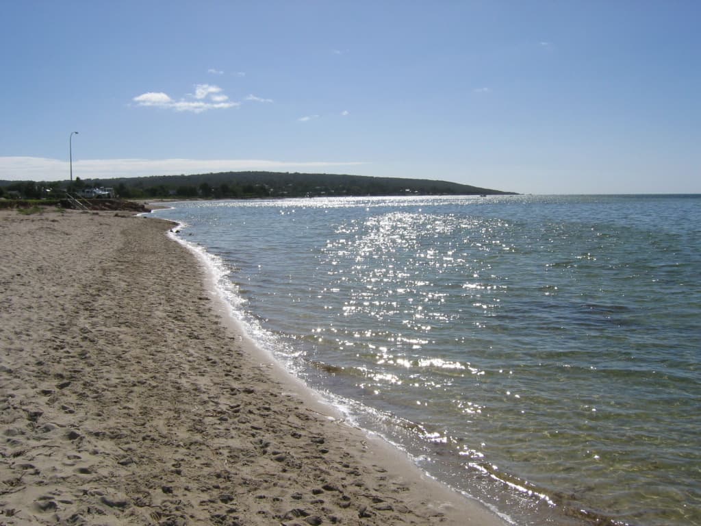 Dunsborough town beach in the late afternoon with the jetty visible